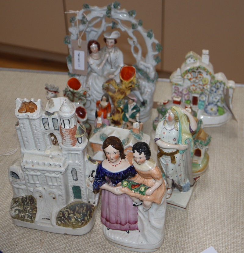 Eleven Staffordshire pottery figures and cottage pastille burners